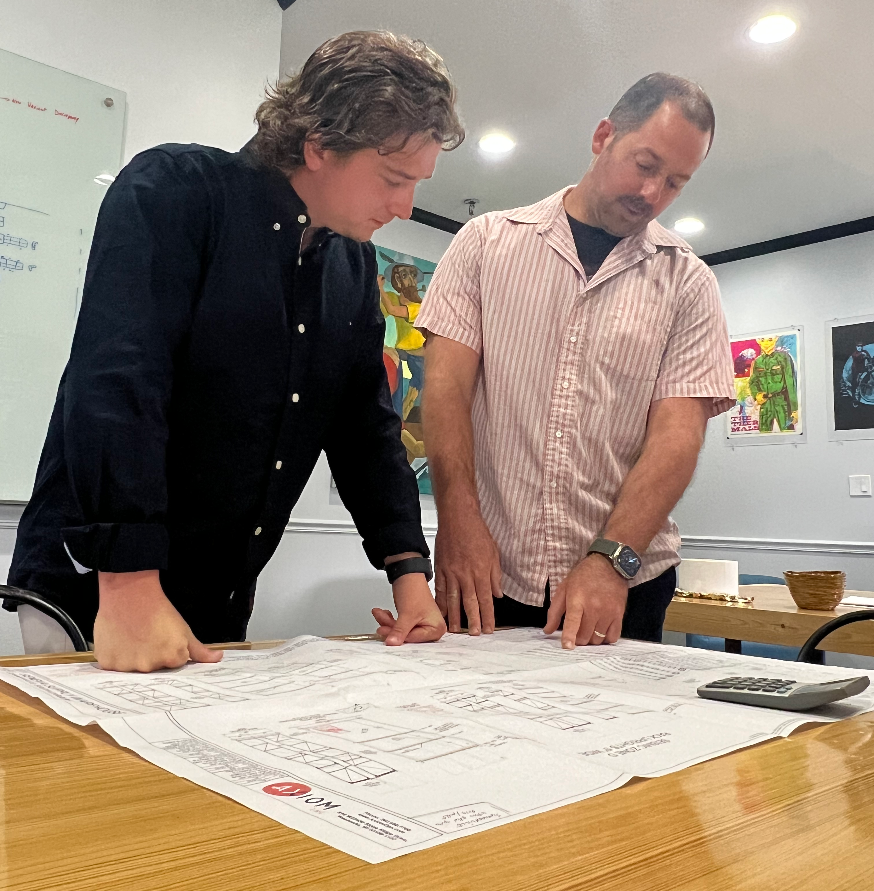 Two men reviewing floor plan of warehouse layout